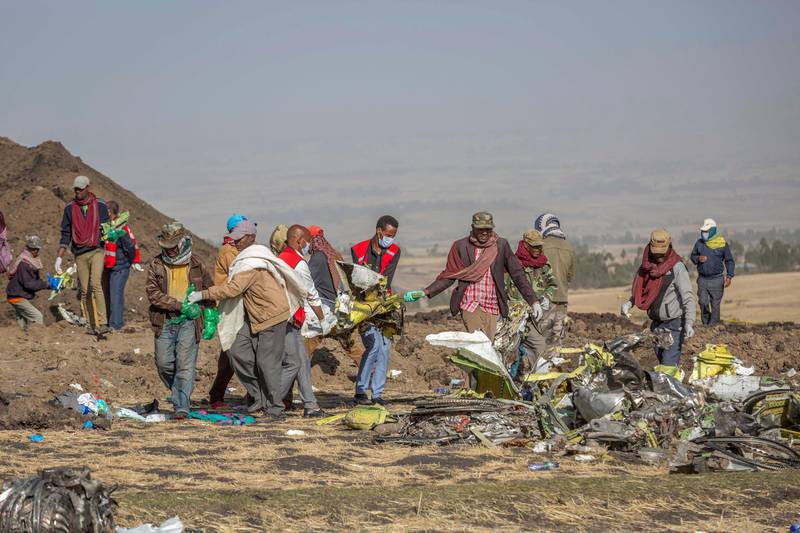 FILE - In this Monday March 11, 2019 file photo, rescuers work at the scene of an Ethiopian Airlines flight crash near Bishoftu, or Debre Zeit, south of Addis Ababa, Ethiopia. The Ethiopian Airlines jet crashed just after taking off from Addis Ababa on March 10, killing all 157 on board. A preliminary report finds that the crew of the Ethiopian Airlines jet that crashed last month performed all the procedures recommended by Boeing but could not control the plane. (AP Photo/Mulugeta Ayene, File)
