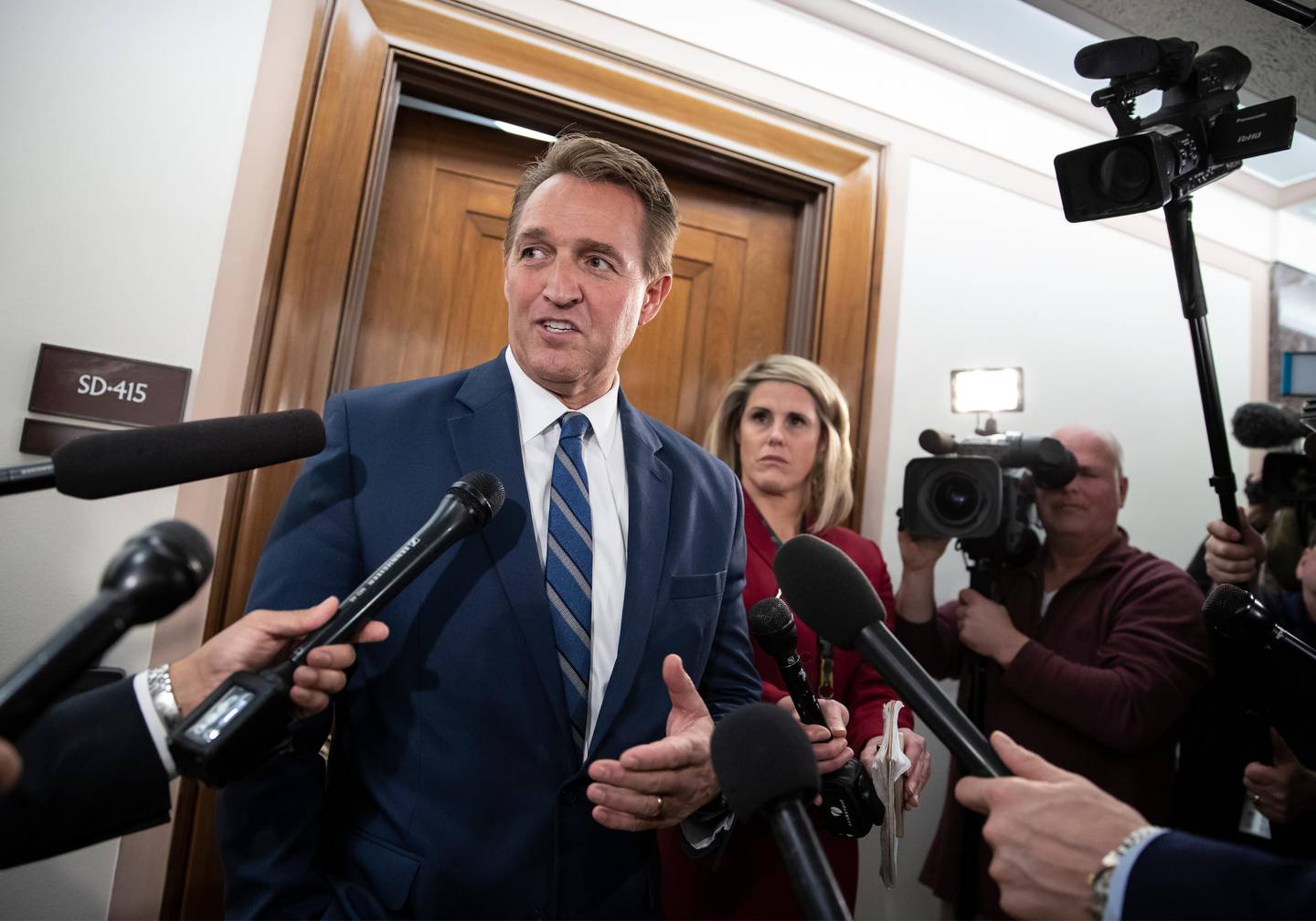 FILE- In this Dec. 6, 2018, file photo, Sen. Jeff Flake, R-Ariz., speaks with reporters on Capitol Hill in Washington.  President Donald Trump?Äôs most prominent GOP critics on Capitol Hill are days away from completing their Senate careers, raising the question of who will take their place as willing to publicly criticize a president who remains popular with Republican voters. Sens. Jeff Flake of Arizona and Bob Corker of Tennessee engaged in a war of words with the president on myriad issues over the past 18 months, generating headlines and fiery tweets from a president who insists on getting the last word. (AP Photo/J. Scott Applewhite, File)