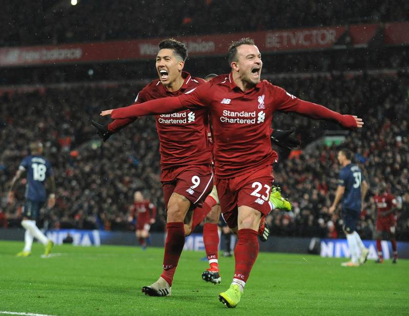 Liverpool's Xherdan Shaqiri, right, celebrates after scoring his side's third goal during the English Premier League soccer match between Liverpool and Manchester United at Anfield in Liverpool, England, Sunday, Dec. 16, 2018. (AP Photo/Rui Vieira)