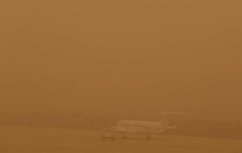 A plane is seen parked on a tarmac during a sandstorm blown over from North Africa known as "calima" at Las Palmas Airport, Canary Islands, Gran Canaria, February 22, 2020. REUTERS/Borja Suarez