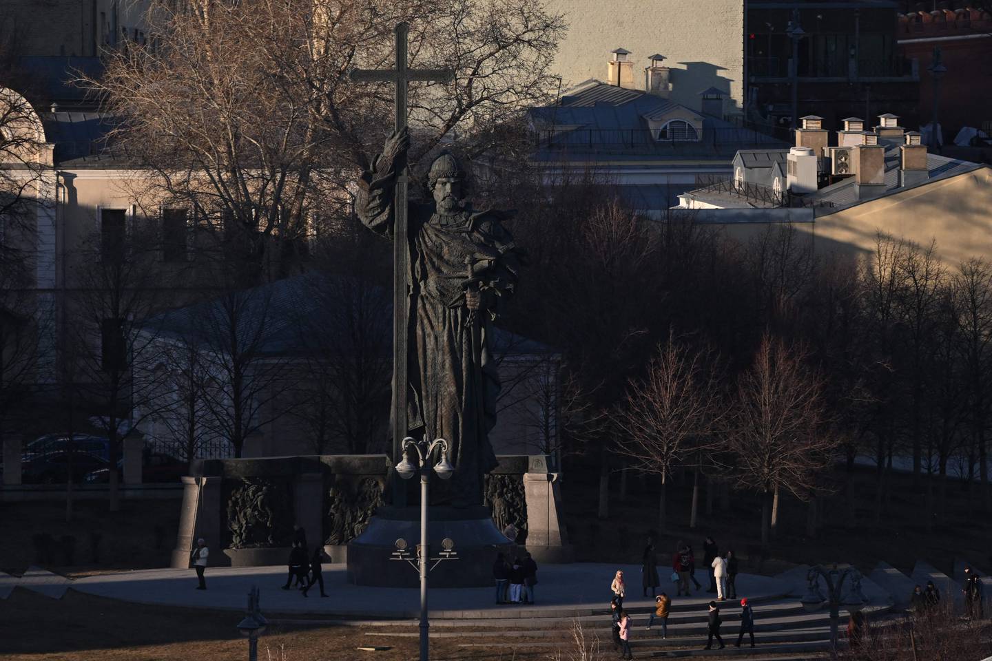 People visit the 17-metre monument of Vladimir the Great, a revered leader and Orthodox saint, in downtown Moscow on March 27, 2024. (Photo by NATALIA KOLESNIKOVA / AFP)