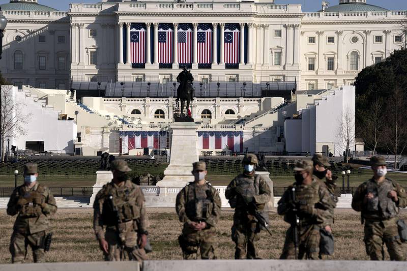 WASHINGTON, DC - JANUARY 14: Members of the National Guard stand outside the U.S. Capitol on January 14, 2021 in Washington, DC. Security has been increased throughout Washington following the breach of the U.S. Capitol last Wednesday, and leading up to the Presidential Inauguration.   Stefani Reynolds/Getty Images/AFP
== FOR NEWSPAPERS, INTERNET, TELCOS & TELEVISION USE ONLY ==