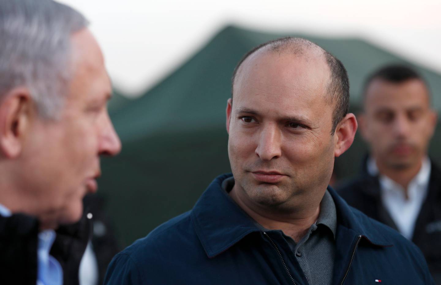 FILE - In this Sunday, Nov. 24, 2019 file photo, Israeli Prime Minister Benjamin Netanyahu, left, and Defense Minister Naftali Bennett, visit an Israeli army base in the Golan Heights, on the Israeli-Syrian border. Bennett is ordering plans for new settler housing in the volatile West Bank city of Hebron. In a letter sent by his office to defense officials Sunday, Dec. 1, 2019, Israels new pro-settler defense minister called for planning processes to be advanced for new Jewish settler housing. (Atef Safadi/Pool via AP, File)