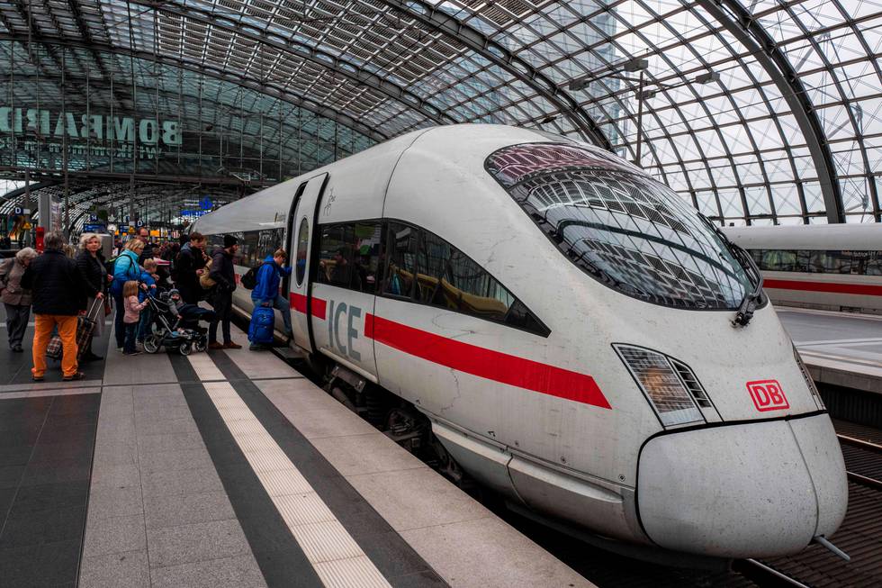 Passengers board an Inter City Express (ICE) train of Germany's Deutsche Bahn (DB) at Berlin's Hauptbahnhof main railway station on October 4, 2018. - Deutsche Bahn have announced further fare increases for December 2018. (Photo by John MACDOUGALL / AFP)
