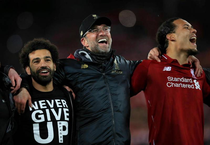 Liverpool's Mohamed Salah, left, manager Jurgen Klopp, center, and Virgil van Dijk celebrate after the Champions League Semi Final, second leg soccer match between Liverpool and Barcelona at Anfield, Liverpool, England, Tuesday, May 7, 2019. Liverpool won the match 4-0 to overturn a three-goal deficit to win the match 4-3 on aggregate. (Peter Byrne/PA via AP)