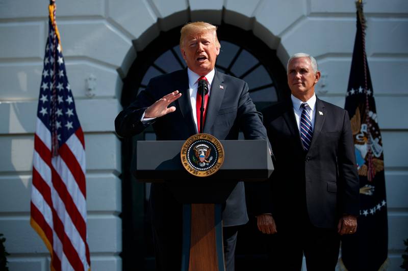 Vice President Mike Pence looks on as President Donald Trump delivers remarks about the economy on the South Lawn of the White House, Friday, July 27, 2018, in Washington. (AP Photo/Evan Vucci)