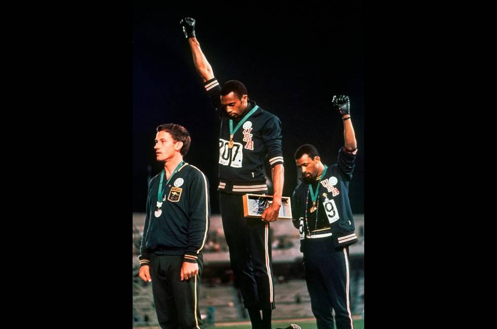 FILE - In this Oct. 16, 1968 file photo, U.S. athletes Tommie Smith, center, and John Carlos raise their gloved fists after Smith received the gold and Carlos the bronze for the 200 meter run at the Summer Olympic Games in Mexico City. The International Olympic Committee published guidelines Thursday, Jan. 9, 2020 specifying which types of athlete protests will not be allowed at the 2020 Tokyo Games. Athletes are prohibited by the Olympic Charter's Rule 50 from taking a political stand in the field of play  like the raised fists by American sprinters Tommie Smith and John Carlos at the 1968 Mexico City Games. (AP Photo, file)