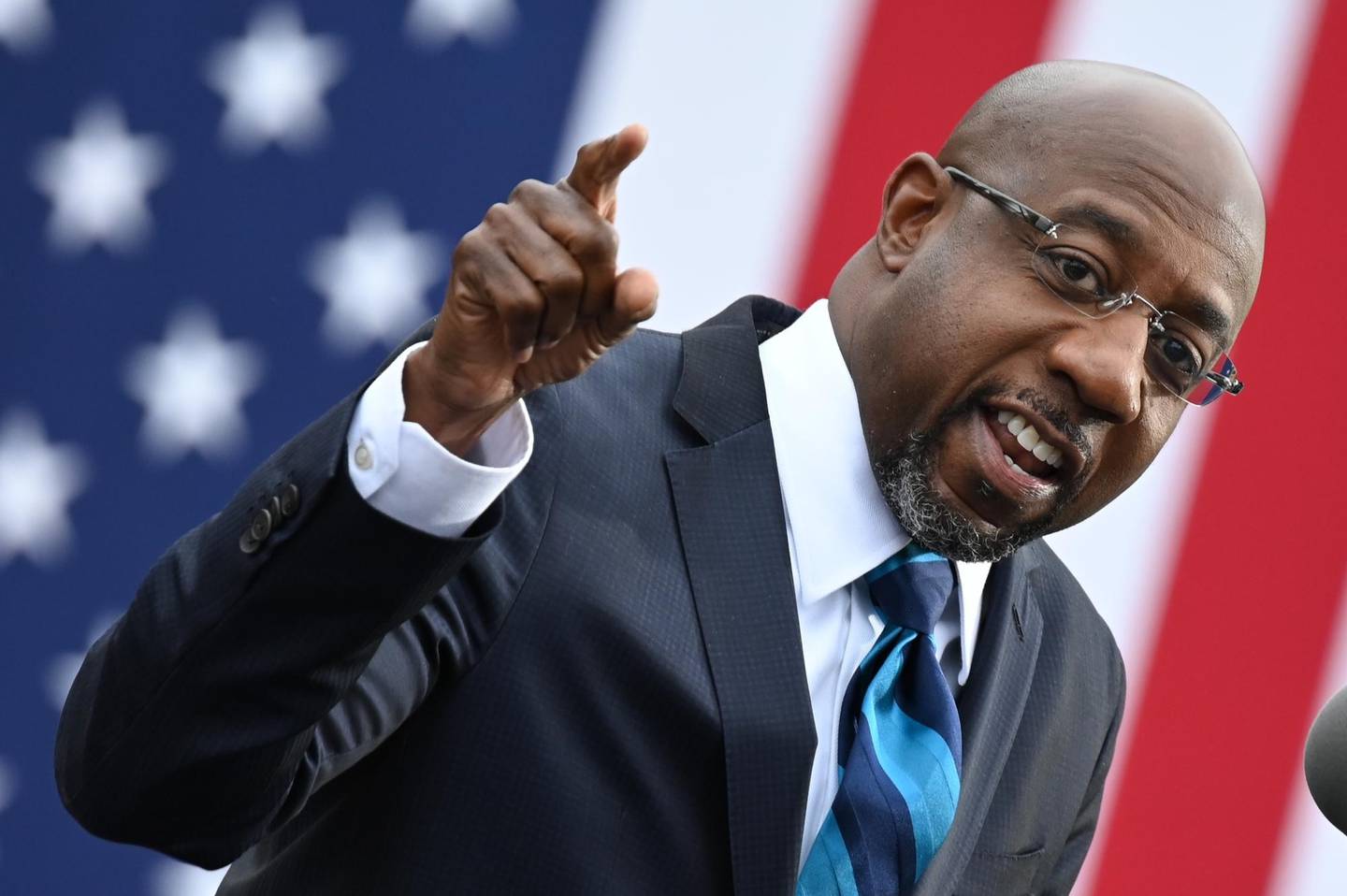 (FILES) In this file photo taken on December 15, 2020 Democratic Senate candidate Reverend Raphael Warnock speaks during a campaign rally in Atlanta, Georgia. - Democrat Raphael Warnock ousted an incumbent Republican onJanuary 6, 2021 in the first of two critical runoff elections in Georgia that will decide control of the US Senate at the outset of Joe Biden's presidency, networks projected. (Photo by JIM WATSON / AFP)