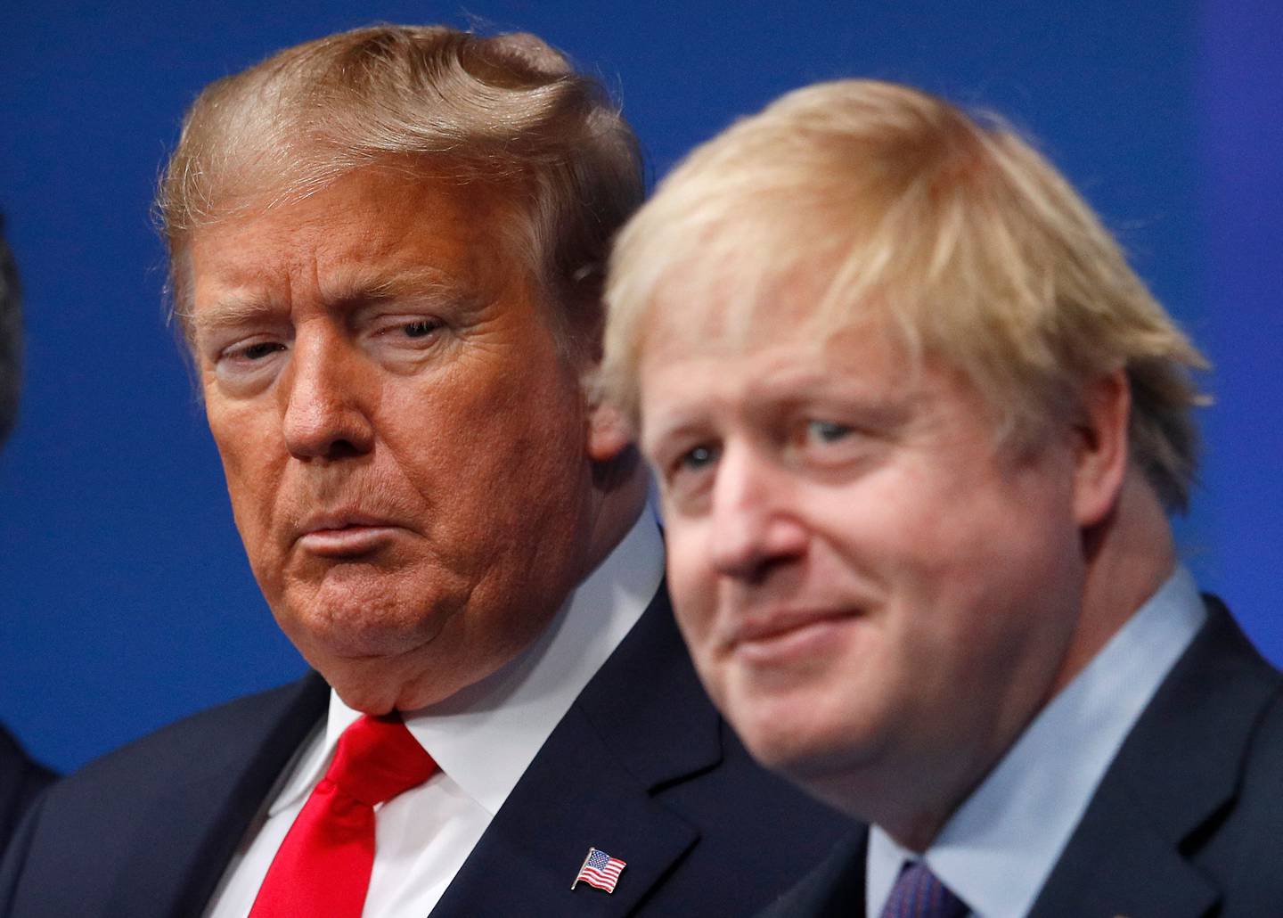 (FILES) In this file photo taken on December 04, 2019 Britain's Prime Minister Boris Johnson (R) welcomes US President Donald Trump (L) to the NATO summit at the Grove hotel in Watford, northeast of London. - Boris Johnson rode his luck throughout his career, bouncing back from a succession of setbacks and scandals that would have sunk other less popular politicians. But the luck of a man once likened to a "greased piglet" for his ability to escape controversies finally ran out, after a slew of high-profile resignations from his scandal-hit government. (Photo by PETER NICHOLLS / various sources / AFP)