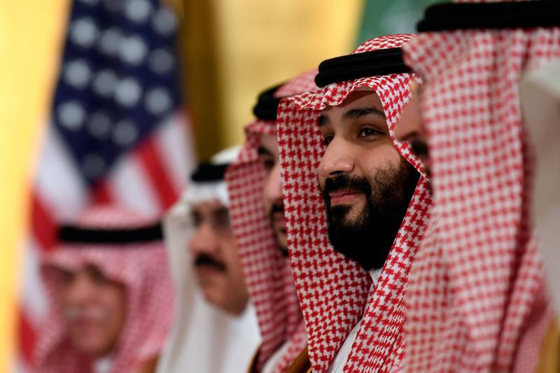 FILE - In this June 29, 2019 file photo, Saudi Arabia's Crown Prince Mohammed bin Salman listens during his meeting with President Donald Trump on the sidelines of the G-20 summit in Osaka, Japan. A number of prominent world leaders have a personal stake in the outcome of the Nov. 3 U.S. election, with their fortunes depending heavily on the success  or failure  of President Donald Trump. Trump stood by the crown prince in the face of sharp criticism after the killing of Washington Post writer Jamal Khashoggi by Saudi agents in late 2018. (AP Photo/Susan Walsh, File)