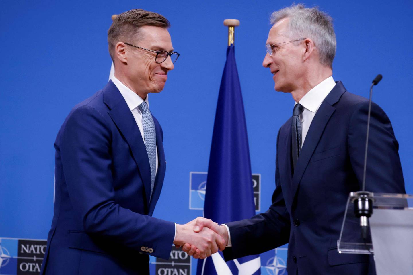 NATO Secretary General, Jens Stoltenberg (R) shakes hands with Finnish President Alexander Stubb after a press conference at the NATO headquarters in Brussels, on April 10, 2024. (Photo by Kenzo TRIBOUILLARD / AFP)