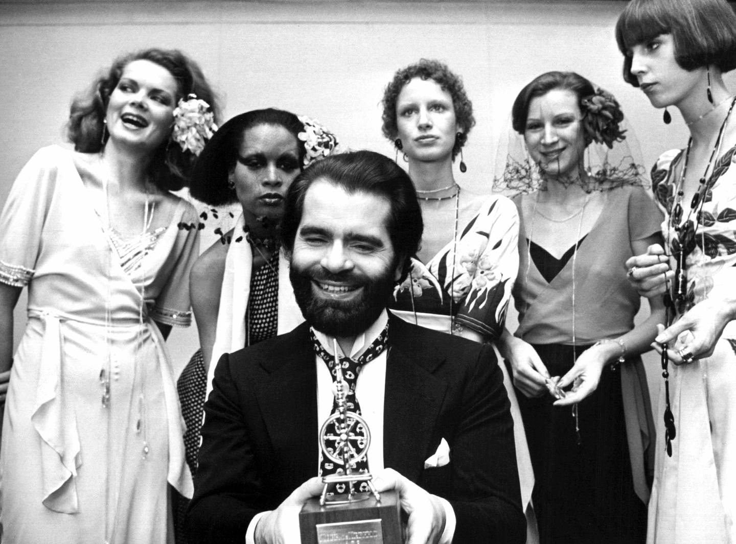 November 29, 1973: Lagerfeld flankert av modeller etter å ha mottatt et trofé for sin design.