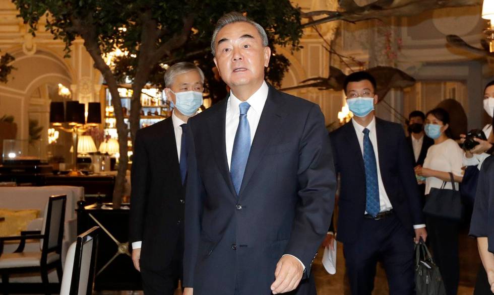 Chinese Foreign Minister Wang Li, followed by his entourage wearing masks to prevent the spread of COVID-19, walks inside the St. Regis Hotel where he met with Canadian Foreign Minister François-Philippe Champagne, in Rome, Tuesday, Aug. 25, 2020. Wang is at the start of a five-nation European tour, which also includes stops in France, Germany, the Netherlands and Norway, his first foreign trip since the coronavirus outbreak in China that turned into a global pandemic. (AP Photo/Andrew Medichini)
