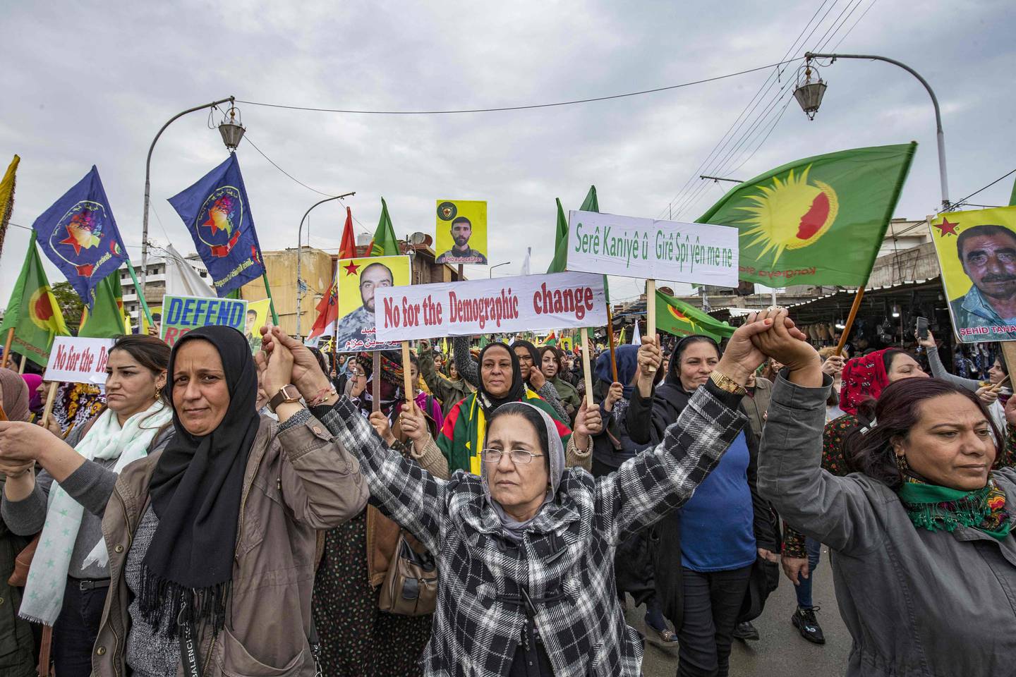 Syrian Kurdish protesters wave signs and chant slogans during a demonstration against Turkish threats in the northeastern city of Qamishli, the de-facto capital of Syria's embattled Kurdish minority, on November 2, 2019. - A complex Russian-Turkish ceasefire deal struck last week has left Qamishli's Kurds uncertain about their future. (Photo by Delil SOULEIMAN / AFP)