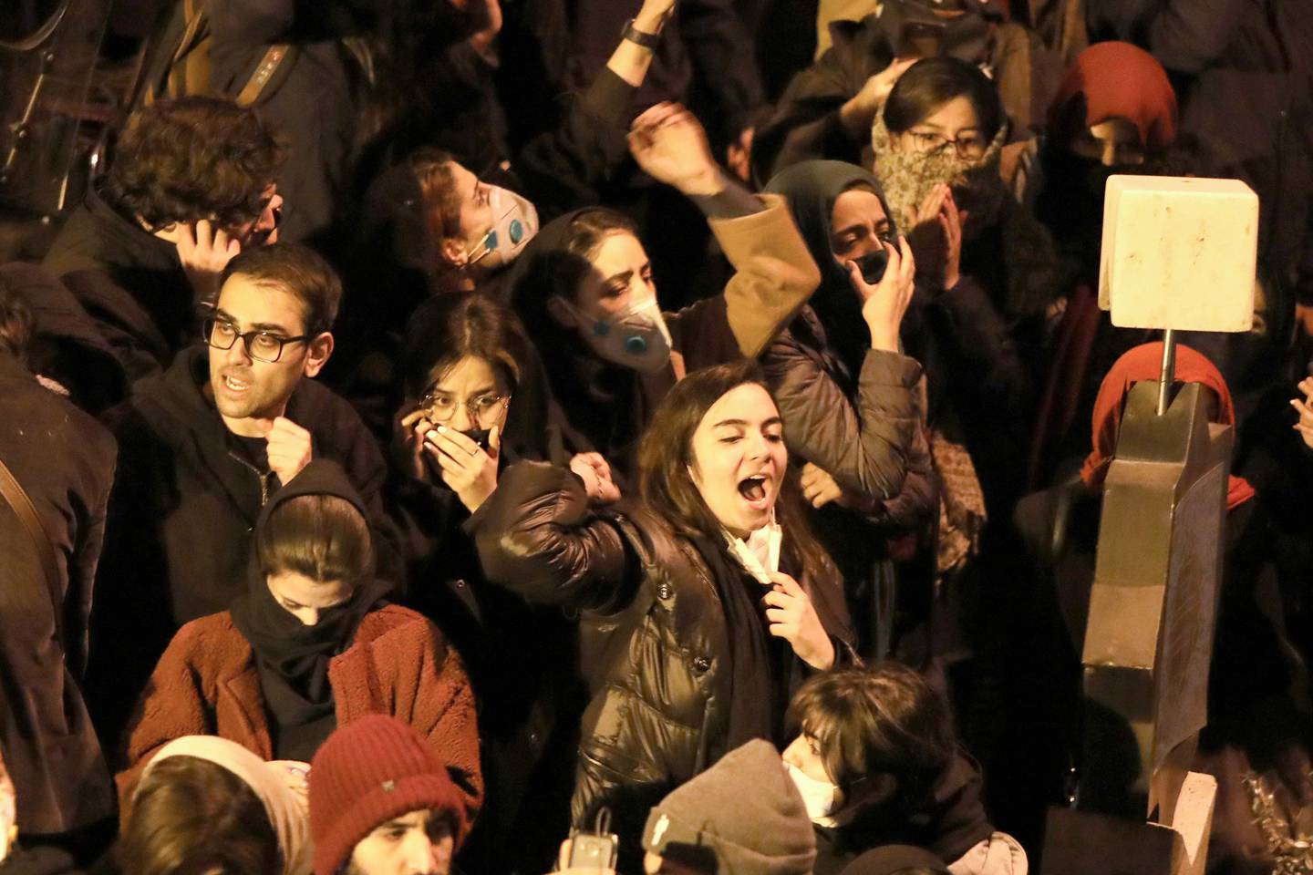 Iranians students chant slogans as they demonstrate following a tribute for the victims of Ukraine International Airlines Boeing 737 in front of the Amirkabir University in the capital Tehran, on January 11, 2020. - Iranian police dispersed students chanting "radical" slogans during a gathering in Tehran to honour the 176 people killed when an airliner was mistakenly shot down, Fars news agency reported. AFP correspondents said hundreds of students had gathered early in the evening at Amir Kabir University, in downtown Tehran, to pay respects to those killed in the air disaster. (Photo by ATTA KENARE / AFP)