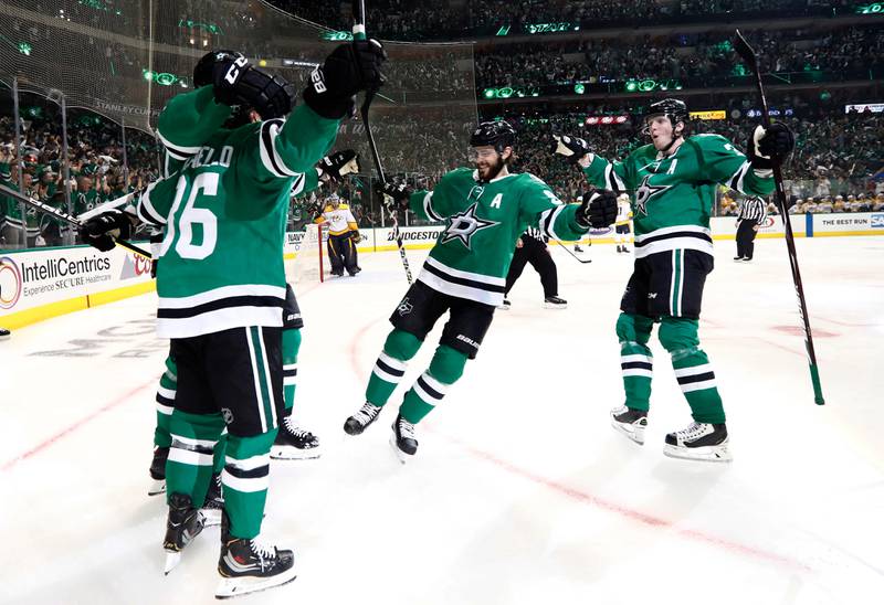 Dallas Stars' Mats Zuccarello (36), Tyler Seguin, center, and John Klingberg, right, celebrate with Roope Hintz, left rear, after Hintz scored in the first period of Game 4 against the Nashville Predators in an NHL hockey first-round playoff series in Dallas, Wednesday, April 17, 2019. (AP Photo/Tony Gutierrez)