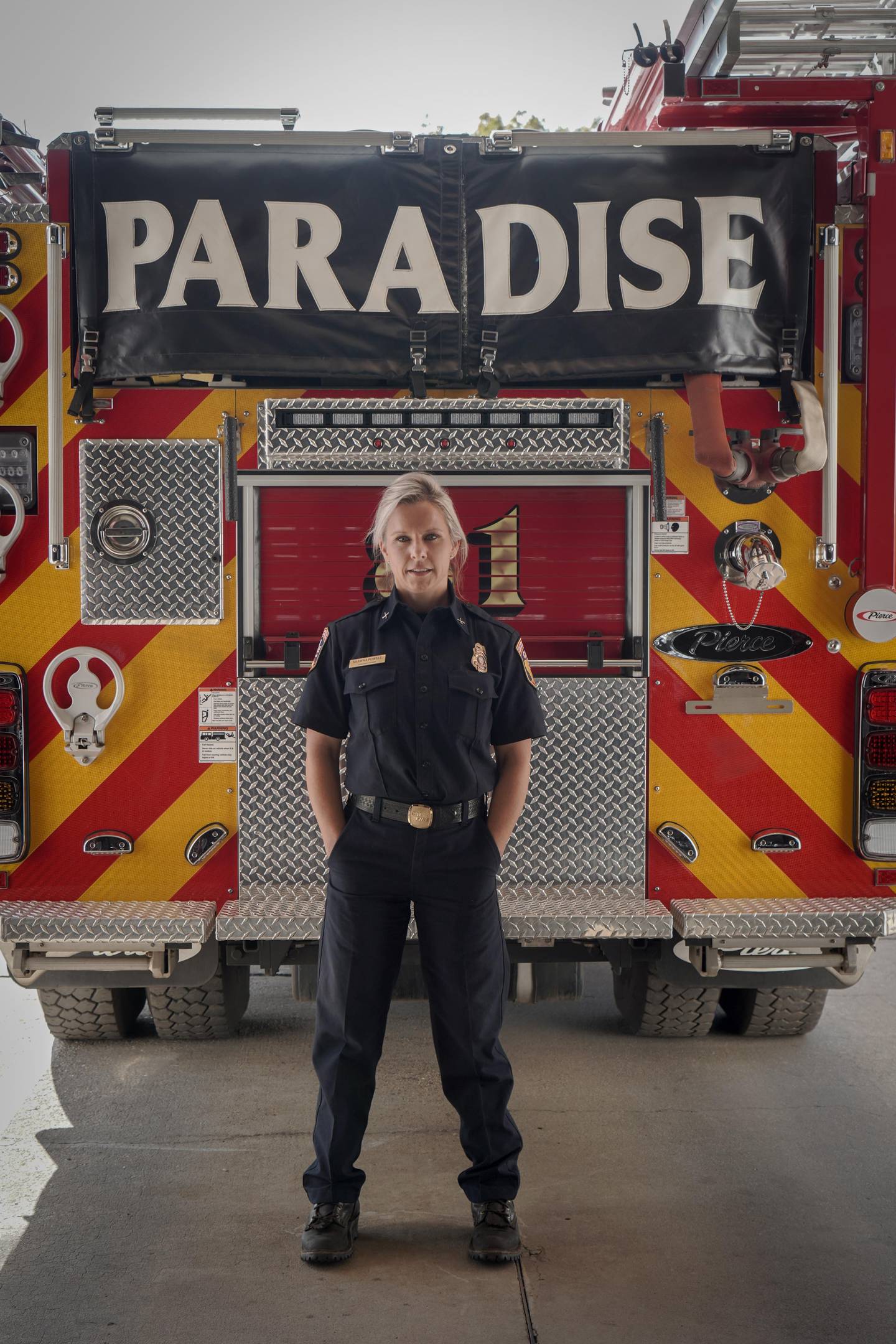 Shawna Powell, Cal Fire Northern Region Peer Support Battalion Chief, stands in front of a Paradise Fire Department fire truck Paradise, CA in REBUILDING PARADISE. (National Geographic/Sarah Soquel Morhaim)