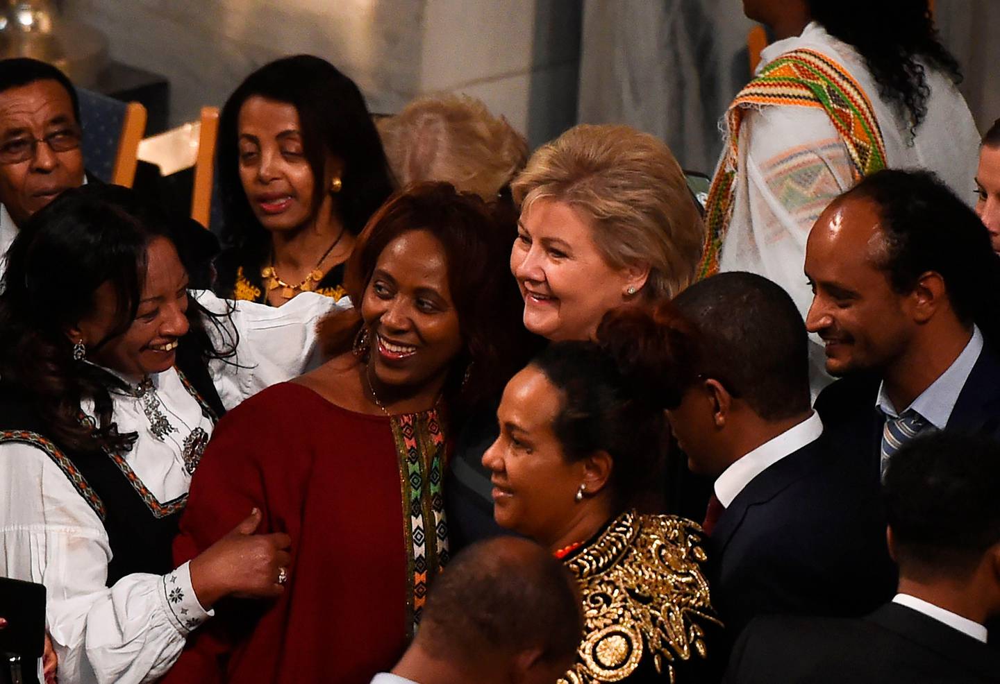 Norwegian prime minister Erna Solberg (C) pose for a picture with guests upon arrival for the Nobel Peace Prize ceremony at the city hall in Oslo on December 10, 2019. - The Ethiopian prime minister Abiy Ahmed is picking up his Nobel Peace Prize in the Norwegian capital as ethnic violence is on the rise at home, festivities are being kept to the bare minimum and he has refused to speak to the media cancelling this years Nobel Peace Prize press conference. (Photo by Fredrik VARFJELL / AFP)