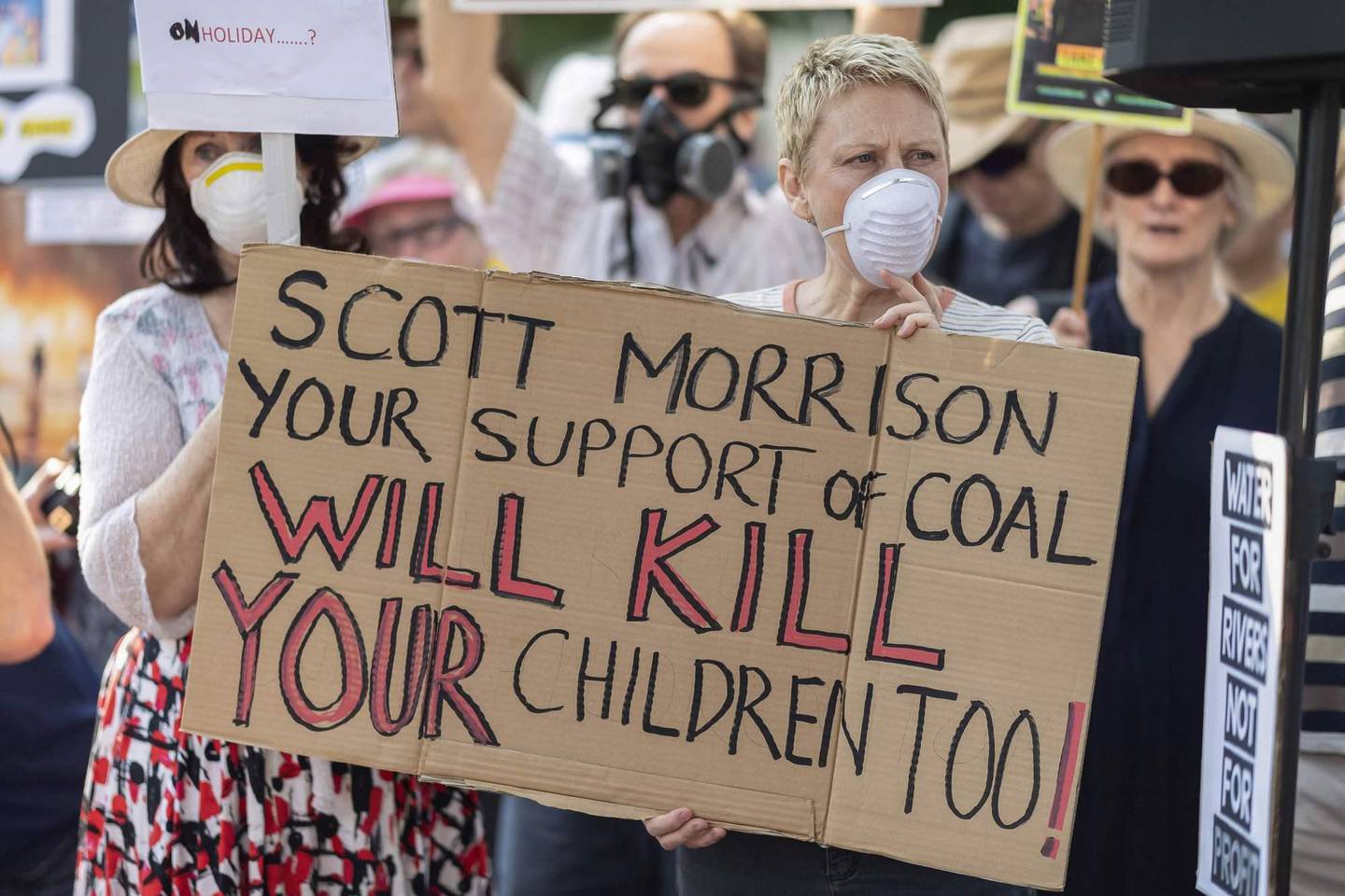 Demonstrators attend a climate protest in Sydney on December 19, 2019. - Protesters marched on Australian Prime Minister Scott Morrison's official residence in Sydney to demand curbs on greenhouse gas emissions and highlight his absence on an overseas holiday as bushfires burned across the region. (Photo by Wendell TEODORO / AFP)