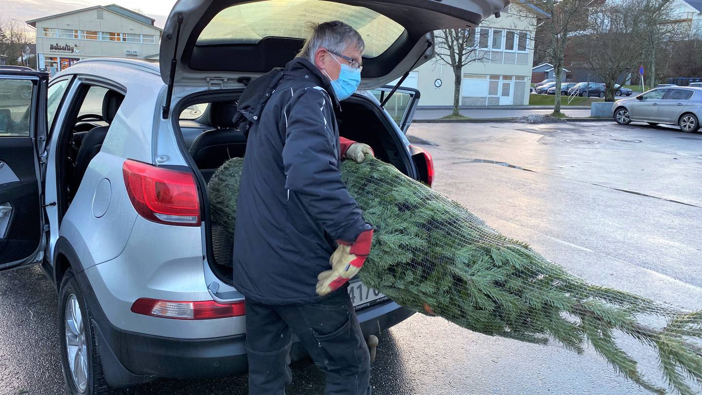 Leif Erlandsen fra Kråkerøy IL plasserer et nylig solgt juletre i bagasjerommet på bilen til kunden.