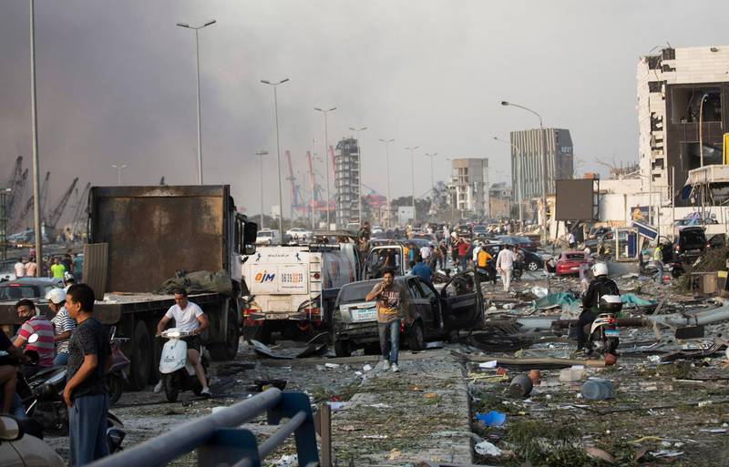 People evacuate wounded after of a massive explosion in Beirut, Lebanon, Tuesday, Aug. 4, 2020. (AP Photo/Hassan Ammar)
