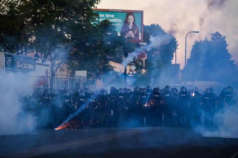Police launch tear gas and fire rubber bullets toward protestors and the media near near the 5th police precinct during a demonstration to call for justice for George Floyd, a black man who died while in custody of the Minneapolis police, on May 30, 2020 in Minneapolis, Minnesota. - Curfews were imposed in major US cities Saturday as clashes over police brutality escalated across America with demonstrators ignoring warnings from President Donald Trump that his government would stop the violent protests "cold." (Photo by CHANDAN KHANNA / AFP)