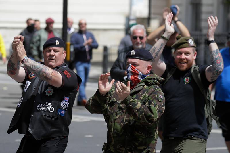 Members of far-right groups gather at The Cenotaph war memorial, protesting against an expected Black Lives Matter demonstration, along Whitehall in central London, Saturday, June 13, 2020. British police have imposed strict restrictions on groups planning to protest in London Saturday in a bid to avoid violent clashes between protesters from the Black Lives Matter movement, as well as far-right groups. (AP Photo/Kirsty Wigglesworth)