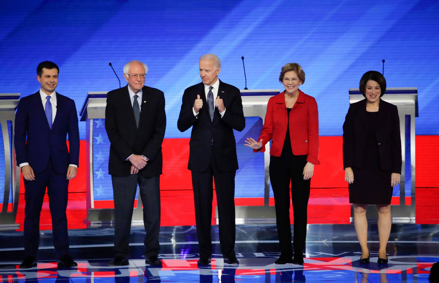 From left, Democratic presidential candidates former South Bend Mayor Pete Buttigieg, Sen. Bernie Sanders, I-Vt., former Vice President Joe Biden, Sen. Elizabeth Warren, D-Mass., and Sen. Amy Klobuchar, D-Minn., stand on stage Friday, Feb. 7, 2020, before the start of a Democratic presidential primary debate hosted by ABC News, Apple News, and WMUR-TV at Saint Anselm College in Manchester, N.H. (AP Photo/Elise Amendola)