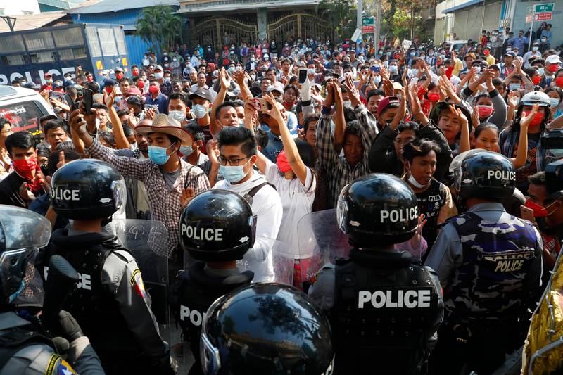 Residents and protesters face riot police as they question them about recent arrests made in Mandalay, Myanmar, Saturday, Feb. 13, 2021. Daily rallies against the coup occurring in Myanmar's two largest cities, Yangon and Mandalay, enter its second week despite a ban on public gatherings of five or more. (AP Photo)