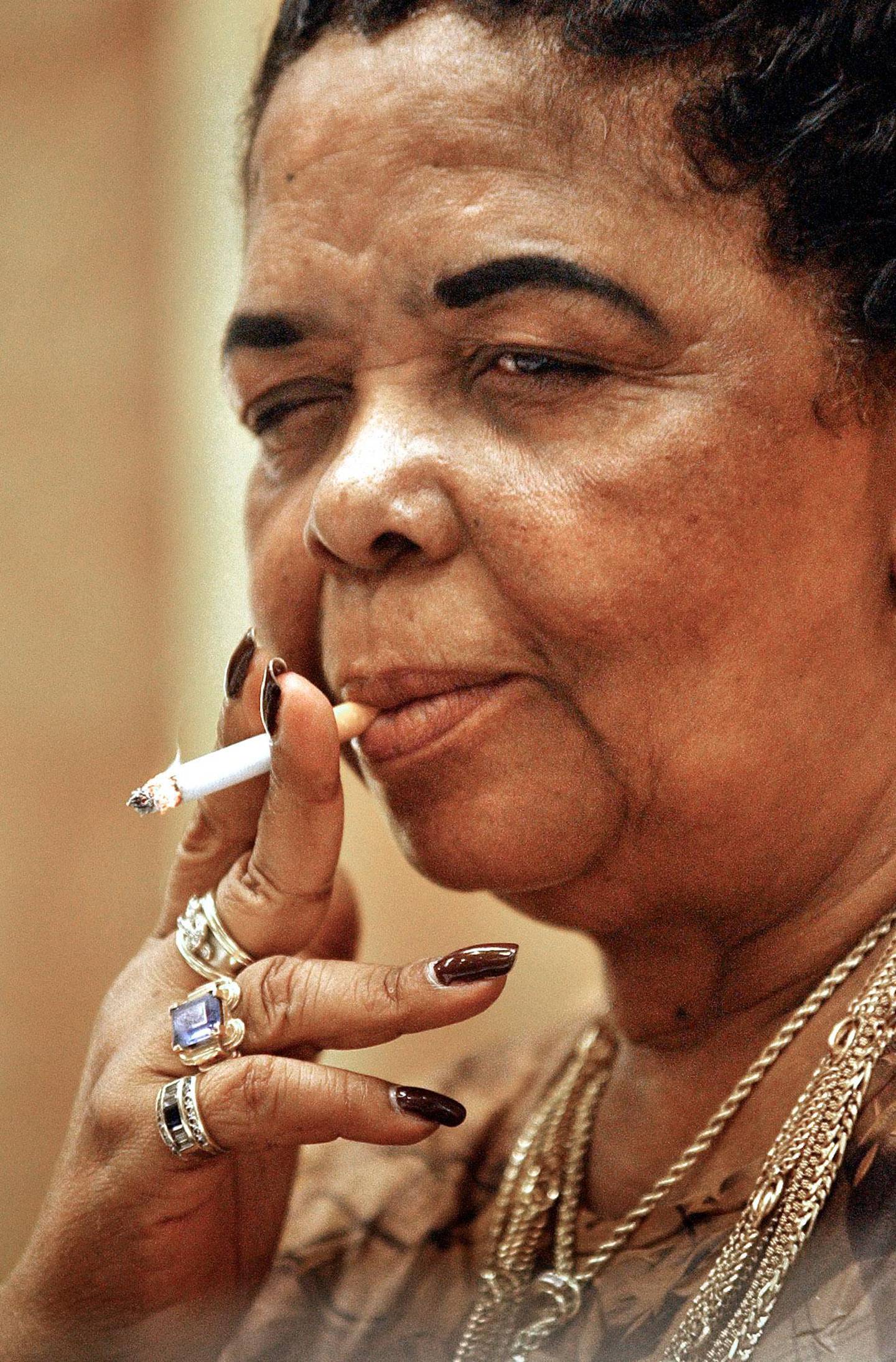 Cesaria Evora, Grammy winning singer from Cape Verde, smokes a cigarette while speaking to Romanian journalists during a  press conference in Bucharest, Romania, Tuesday June 29, 2004. Evora will present her new album in a live performance Tuesday night. (AP Photo/Vadim Ghirda)