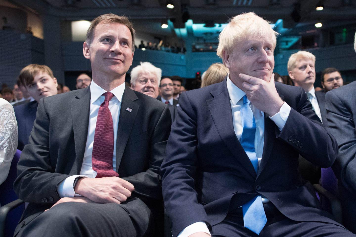 Conservative Party leadership contenders Boris Johnson (R) and Jeremy Hunt (L) sit together at an event to announce the winner of the party's leadership contest in central London on July 23, 2019. - Boris Johnson won the race to become Britain's next prime minister on Tuesday, heading straight into a confrontation over Brexit with Brussels and parliament, as well as a tense diplomatic standoff with Iran. (Photo by Stefan Rousseau / POOL / AFP)