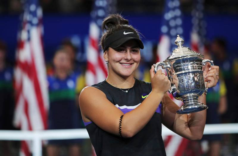 Bianca Andreescu, of Canada, holds up the championship trophy after defeating Serena Williams, of the United States, in the women's singles final of the U.S. Open tennis championships Saturday, Sept. 7, 2019, in New York. (AP Photo/Charles Krupa)