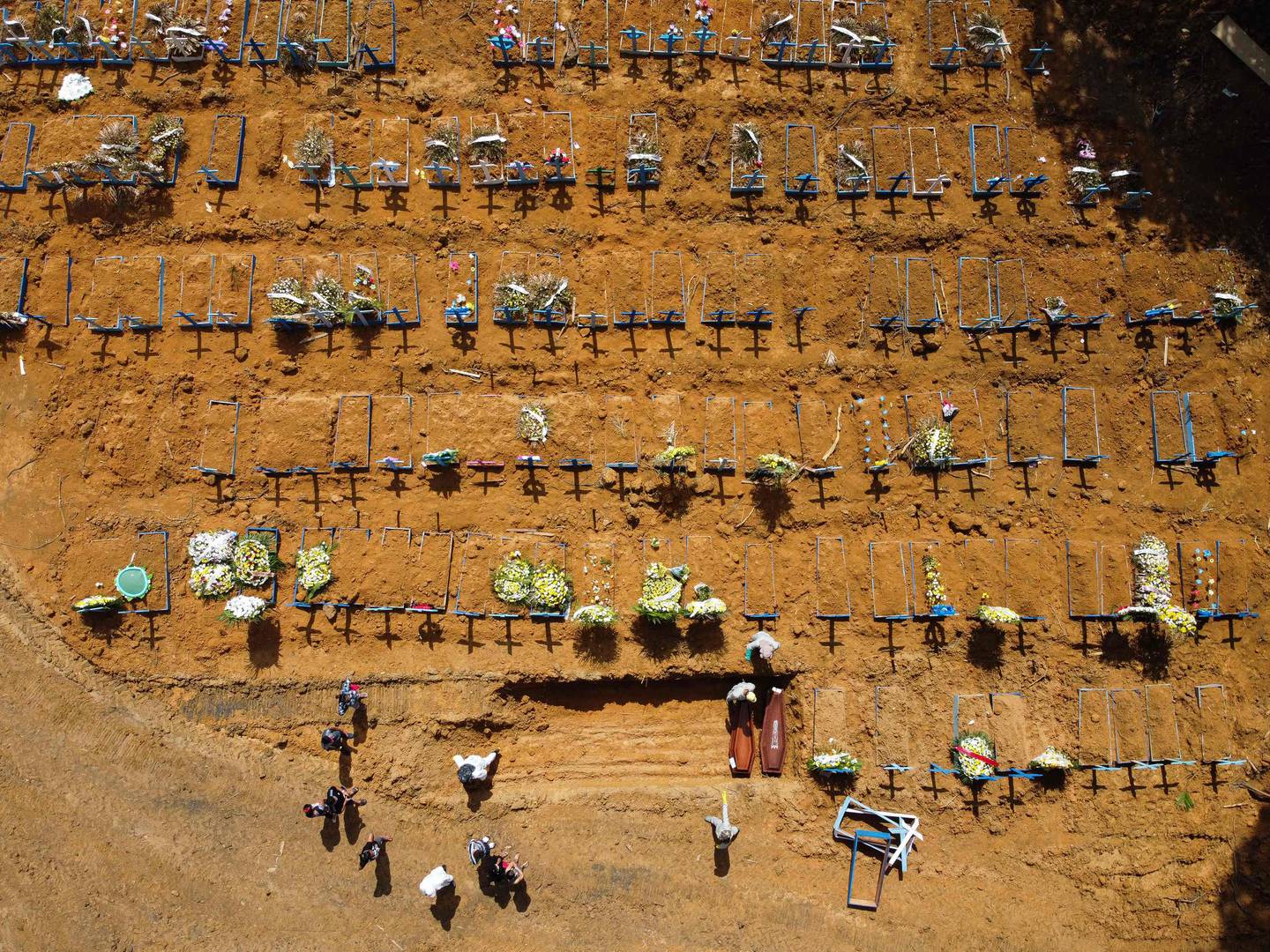 Aerial view showing gravediggers burying a person at the Nossa Senhora Aparecida cemetery in the neighbourhood of Taruma, in Manaus, Brazil, on June 2, 2020 during the COVID-19 novel coronavirus pandemic. - The pandemic has killed at least 375,555 people worldwide since it surfaced in China late last year, according to an AFP tally at 1100 GMT on Tuesday, based on official sources. Brazil is the fourth worst-hit country with 29,937 deaths so far. (Photo by Michael DANTAS / AFP)