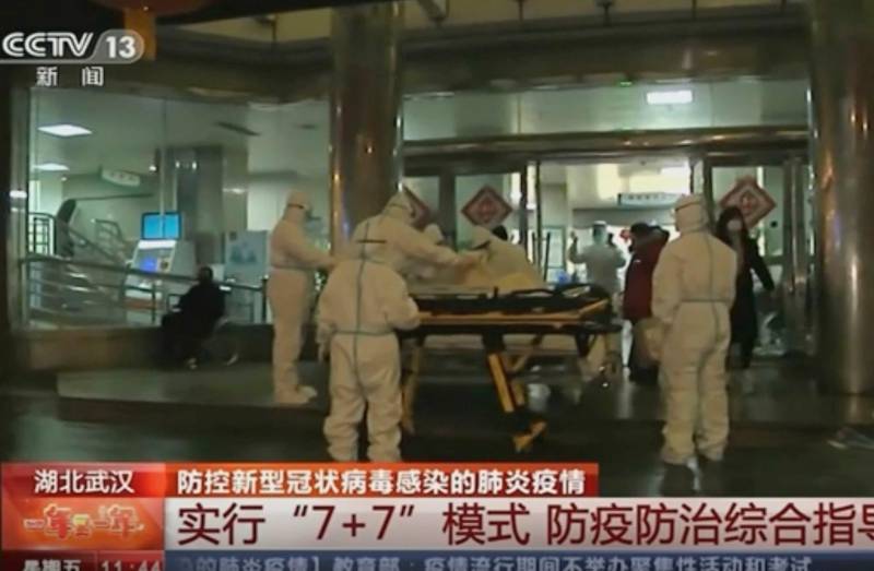 In this Thursday, Jan. 23, 2020, image from China's CCTV video, a patient is carried on a stretcher to an ambulance by medical workers in protective suits in Wuhan, China. China is swiftly building a hospital dedicated to treating patients infected with a new virus that sickened hundreds and prompted unprecedented lockdowns of cities home to millions of people during the country's most important holiday. (CCTV via AP)