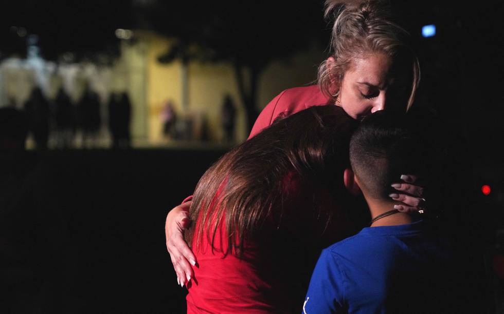 En familie klemmer etter skoleskytingen i Uvalde i Texas 24. mai. 21 mennesker ble drept.