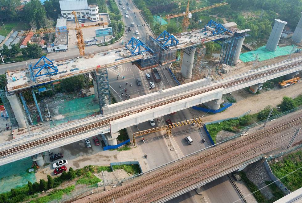This photo taken on July 14, 2019 shows a bridge under construction for China's high-speed rail network in Donghai county, in Lianyungang, in China's eastern Jiangsu province. - China's growth slowed to its weakest pace in almost three decades in the second quarter, with the US-China trade war and weakening global demand weighing on the world's number-two economy, official data showed on July 15. (Photo by STR / AFP) / China OUT