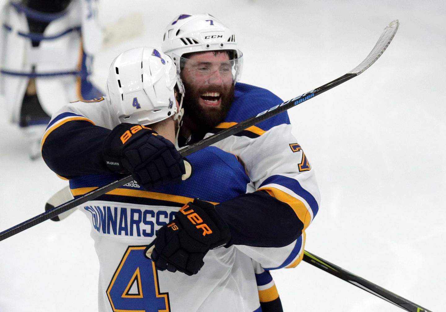 St. Louis Blues' Carl Gunnarsson (4), of Sweden, is congratulated by Pat Maroon, rear, after he scored the winning goal against the Boston Bruins during the first overtime period in Game 2 of the NHL hockey Stanley Cup Final, Wednesday, May 29, 2019, in Boston. (Bruce Bennett/Pool via AP)