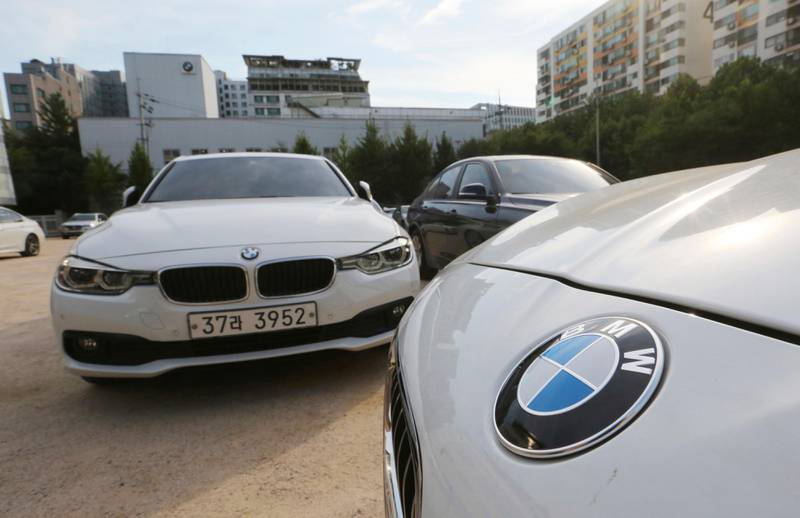 FILE - In this Aug. 14, 2018 file photo, BMW cars are parked for an emergency safety check at the playground of an elementary school near a BMW service center in Seoul, South Korea. South Korea says on Monday, Dec. 24, 2018. it will fine BMW 11.2 billion won ($9.9 million) and file a criminal complaint against the company with state prosecutors over an allegedly botched response to dozens of engine fires reported in the country. (AP Photo/Ahn Young-joon, File)