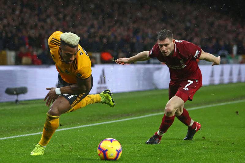 Wolverhampton Wanderers' Spanish striker Adama Traore (L) vies with Liverpool's English midfielder James Milner (R) during the English Premier League football match between Wolverhampton Wanderers and Liverpool at the Molineux stadium in Wolverhampton, central England  on December 21, 2018. (Photo by Geoff CADDICK / AFP) / RESTRICTED TO EDITORIAL USE. No use with unauthorized audio, video, data, fixture lists, club/league logos or 'live' services. Online in-match use limited to 120 images. An additional 40 images may be used in extra time. No video emulation. Social media in-match use limited to 120 images. An additional 40 images may be used in extra time. No use in betting publications, games or single club/league/player publications. / 