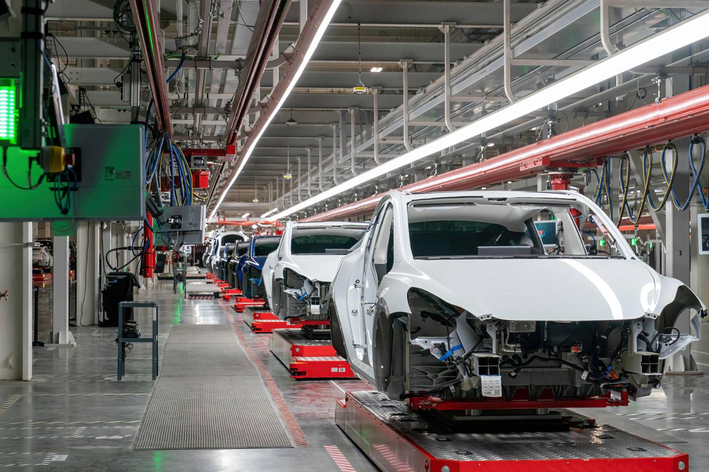 (FILES) Cars are seen on the assembly line during a tour of the Tesla Giga Texas manufacturing facility ahead of the "Cyber Rodeo" grand opening party on April 7, 2022 in Austin. Electric car maker Tesla has initiated a recall of about two million vehicles in the United States over a risk linked to its autopilot software, the US traffic safety regulator said on December 13, 2023. "Tesla has now filed a safety recall with the agency related to its Autopilot software system," the National Highway Traffic Safety Administration (NHTSA) said, adding that "affected vehicles will receive an over-the-air software remedy." (Photo by SUZANNE CORDEIRO / AFP)