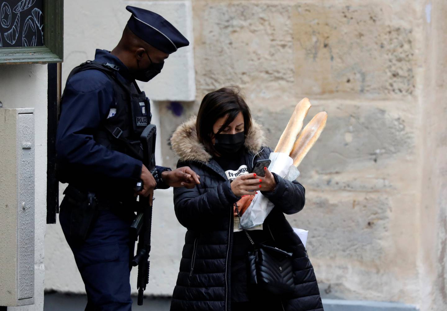 A policeman controls a woman in a street in Paris on the first day of the second national lockdown as part of the COVID-19 measures to fight a second wave of the coronavirus disease (COVID-19), France, October 30, 2020. REUTERS/Charles Platiau