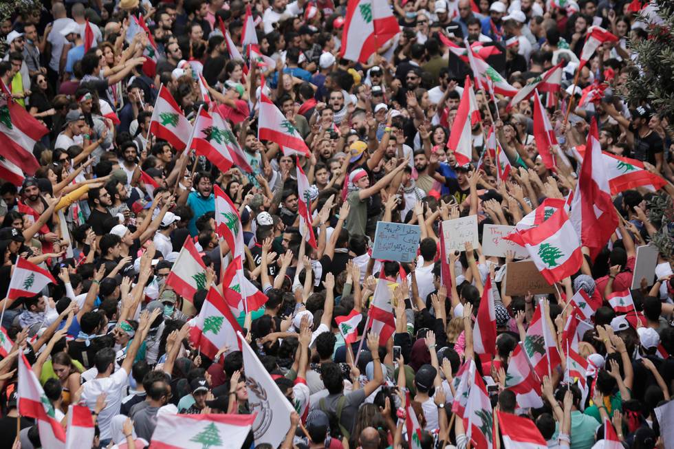 Anti-government protesters shout slogans in Beirut, Lebanon, Sunday, Oct. 20, 2019. Thousands of people are gathering in downtown Beirut as Lebanon is expected to witness the largest protests on the fourth day of anti-government demonstrations. (AP Photo/Hassan Ammar)
