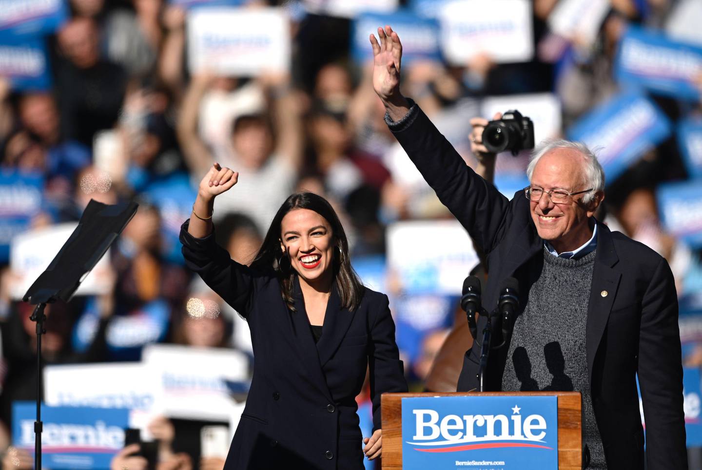 (FILES) In this file photo taken on October 19, 2019, 2020 Democratic presidential hopeful US Senator Bernie Sanders (D-VT) and representative Alexandria Ocasio-Cortez (D-NY) wave to a crowd of supporters during a campaign rally in New York City. - During Biden's campaign, Democratic socialists like Ocasio-Cortez and Vermont's Senator Bernie Sanders -- the runner-up in the 2016 and 2020 primaries -- buried the hatchet with the party's moderates and helped get out the vote. But as the dust settles it is clear that the tensions that arose during the primary over healthcare, student debt and combating climate change and inequality haven't gone anywhere. (Photo by Johannes EISELE / AFP)