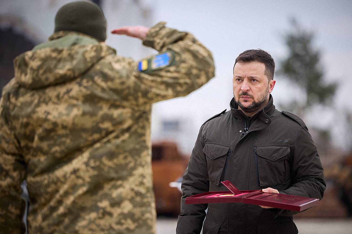 In this handout photograph taken and released by Ukrainian Presidential Press Service on February 24, 2024, Ukraine's President Volodymyr Zelensky gives an award to a Ukrainian serviceman during a ceremony marking the second anniversary of the Russian invasion of Ukraine in Hostomel, Kyiv region. (Photo by Handout / UKRAINIAN PRESIDENTIAL PRESS SERVICE / AFP) / RESTRICTED TO EDITORIAL USE - MANDATORY CREDIT "AFP PHOTO / UKRAINIAN PRESIDENTIAL PRESS SERVICE " - NO MARKETING NO ADVERTISING CAMPAIGNS - DISTRIBUTED AS A SERVICE TO CLIENTS