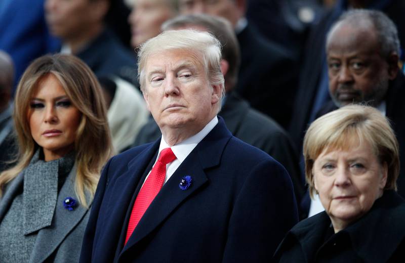 President Donald Trump, his wife Melania Trump, left, and German Chancellor Angela Merkel attend ceremonies at the Arc de Triomphe Sunday, Nov. 11, 2018 in Paris. . Over 60 heads of state and government were taking part in a solemn ceremony at the Tomb of the Unknown Soldier, the mute and powerful symbol of sacrifice to the millions who died from 1914-18.. (AP Photo/Francois Mori, Pool)