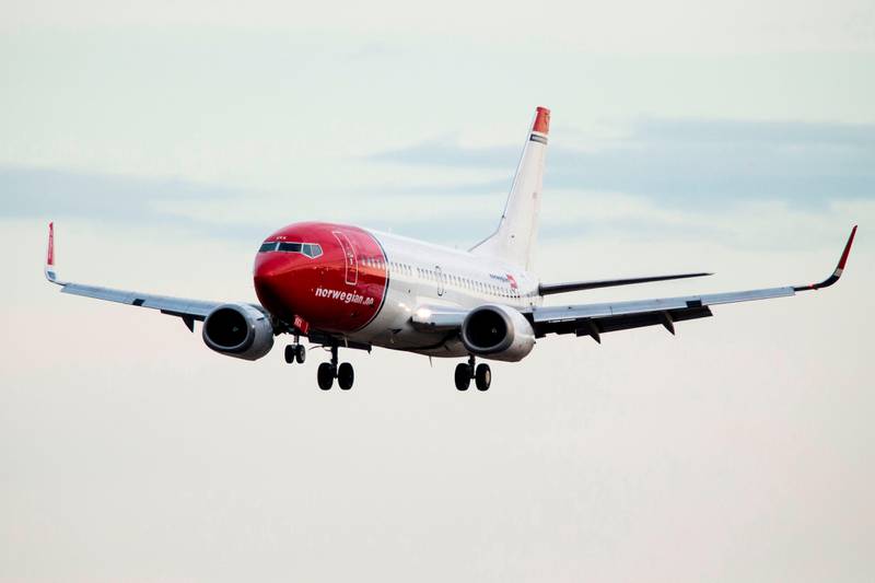 (FILES) In this file photo taken on May 02, 2014 shows a Boeing 737-33S operated by Norwegian Air Shuttle ahead of landing at the Oslo Airport Gardemoen. - Embattled low-cost carrier Norwegian Air Shuttle on December 3, 2020 unveiled the details of its restructuring plan aimed at rescuing it from bankruptcy. Among the measures are a downsizing of its fleet, debt conversion and a rights issue of up to four billion kroner (USD 453 million, 374.5 million euros). Norwegian, Europe's third-biggest low-cost airline, has called an extraordinary general assembly for December 17, 2020 to seek shareholders' approval for the measures. (Photo by Erlend AAS / NTB SCANPIX / AFP)