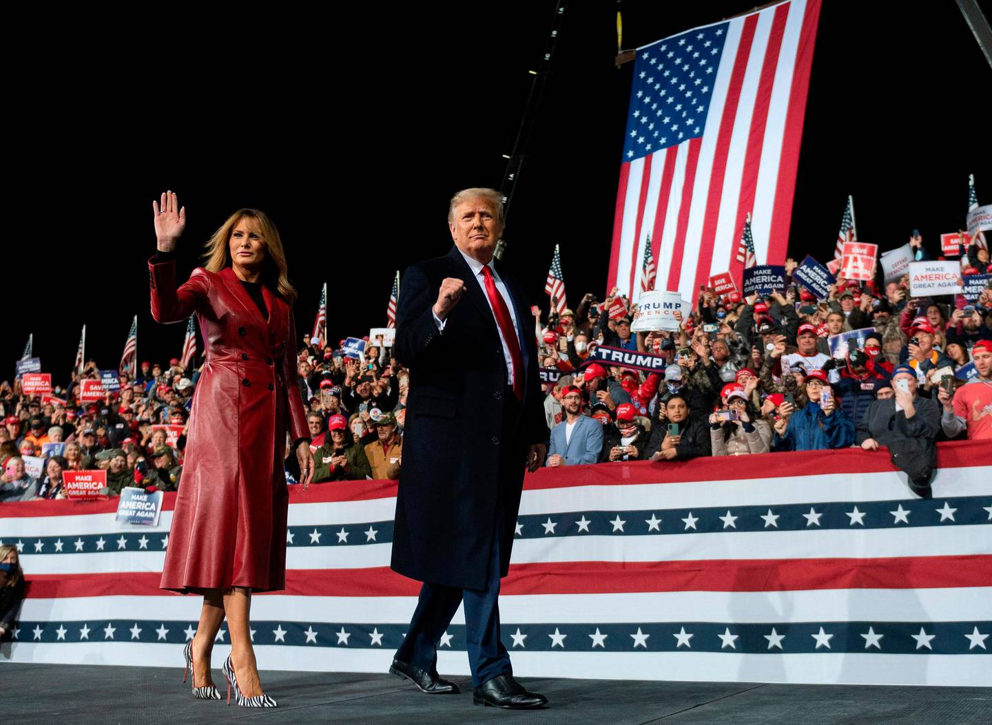 US President Donald Trump leaves the stage with First Lady Melania Trump at the end of a rally to support Republican Senate candidates at Valdosta Regional Airport in Valdosta, Georgia on December 5, 2020. - President Donald Trump ventures out of Washington on Saturday for his first political appearance since his election defeat to Joe Biden, campaigning in Georgia where two run-off races will decide the fate of the US Senate. (Photo by ANDREW CABALLERO-REYNOLDS / AFP)