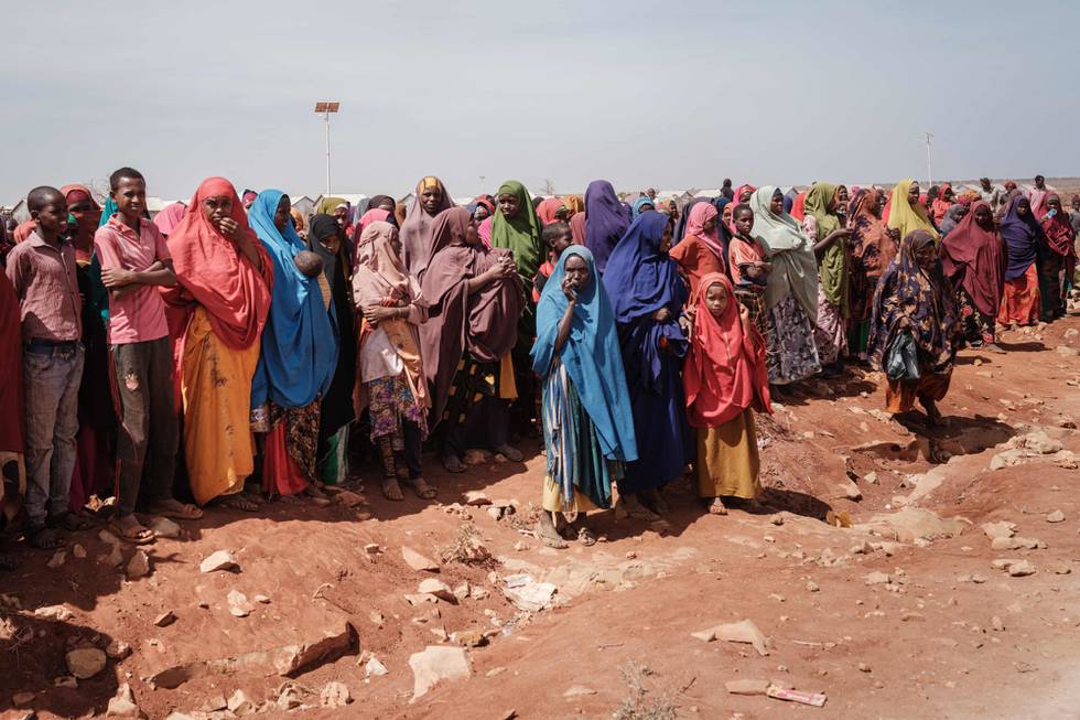 People wait for food distributions and health services at a camp for internally displaced persons (IDPs) in Baidoa, Somalia, on February 14, 2022. Insufficient rainfall since late 2020 has come as a fatal blow to populations already suffering from a locust invasion between 2019 and 2021, the Covid-19 pandemic. For several weeks, humanitarian organizations have multiplied alerts on the situation in the Horn of Africa, which raises fears of a tragedy similar to that of 2011, the last famine that killed 260,000 people in Somalia. - Desperate, hungry and thirsty, more and more people are flocking to Baidoa from rural areas of southern Somalia, one of the regions hardest hit by the drought that is engulfing the Horn of Africa. (Photo by YASUYOSHI CHIBA / AFP)