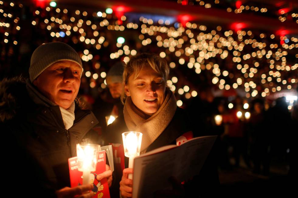 28.500 mennesker deltok med sang og tente lys på årets julesangfest på Alte Foersterei stadion i Berlin lille julaften. FOTO: HANNIBAL HANSCHKE/NTB SCANPIX
