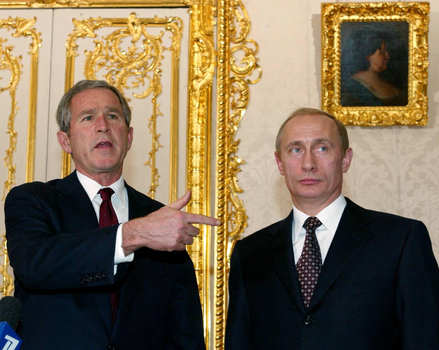 U.S. President George W. Bush gestures speaking to journalists as Russian President Vladimir Putin stands by in Catherine Palace in Pushkin outside St. Petersburg, Russia, Friday Nov. 22, 2002. Bush came to St. Petersburg from a historic NATO summit in Prague one day after the alliance agreed to expand its membership into the territory of the former Soviet Union. (AP Photo/Dmitry Astakhov, Izvestia, pool)
